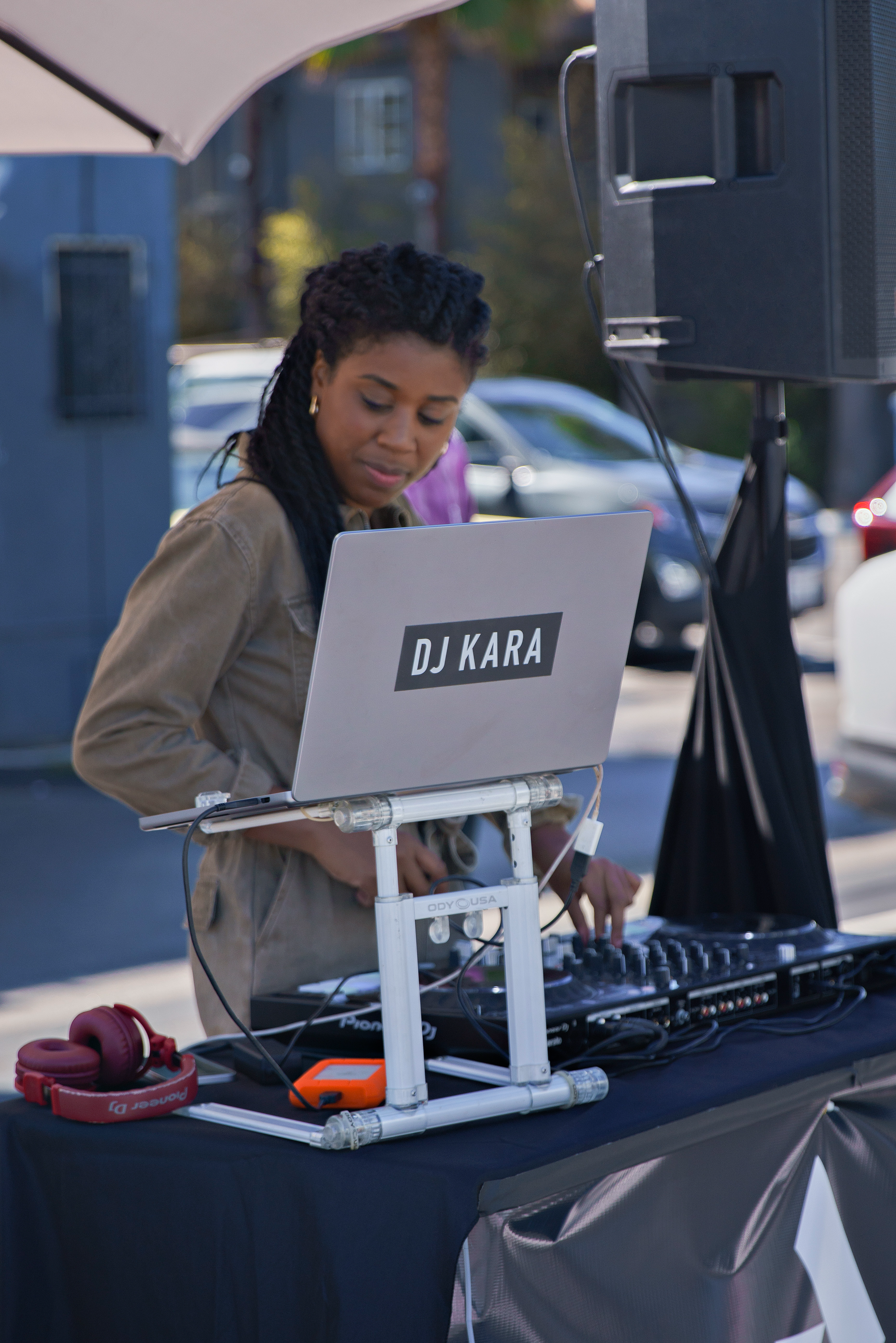 Brighter Community Venice Beach DJ Kara mixing music at event