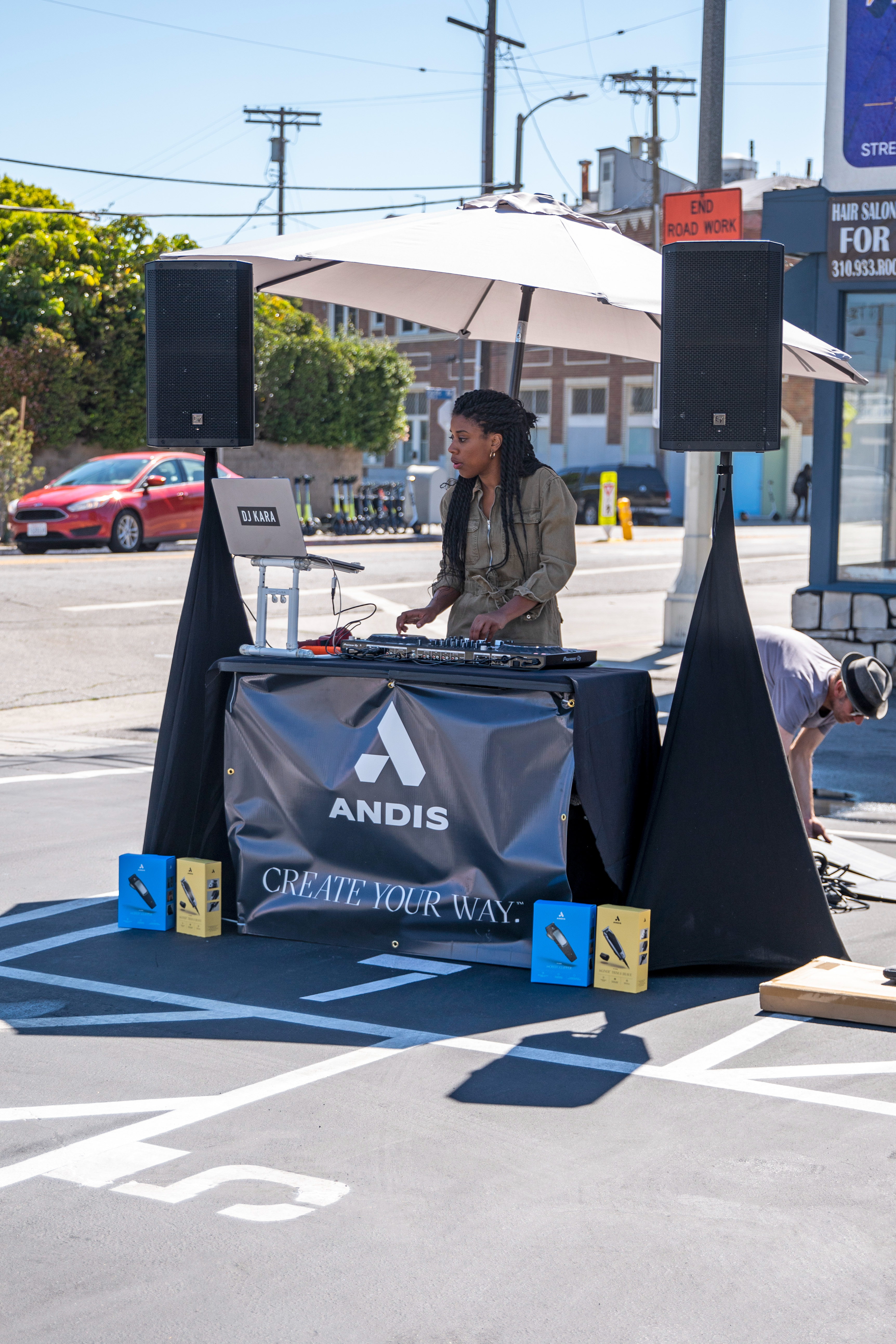 Brighter Community Venice Beach DJ Kara mixing music at event view